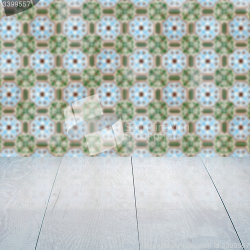 Image of Wood table top and blur vintage ceramic tile pattern wall