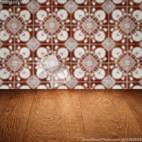 Image of Wood table top and blur vintage ceramic tile pattern wall