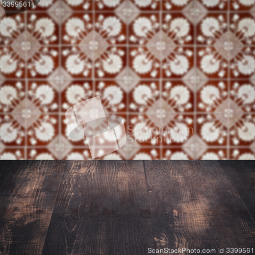 Image of Wood table top and blur vintage ceramic tile pattern wall