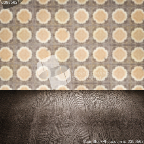 Image of Wood table top and blur vintage ceramic tile pattern wall