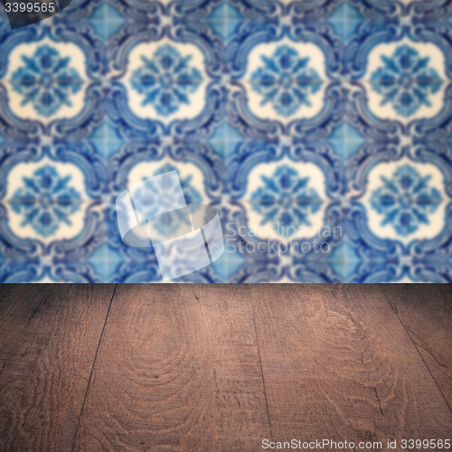 Image of Wood table top and blur vintage ceramic tile pattern wall