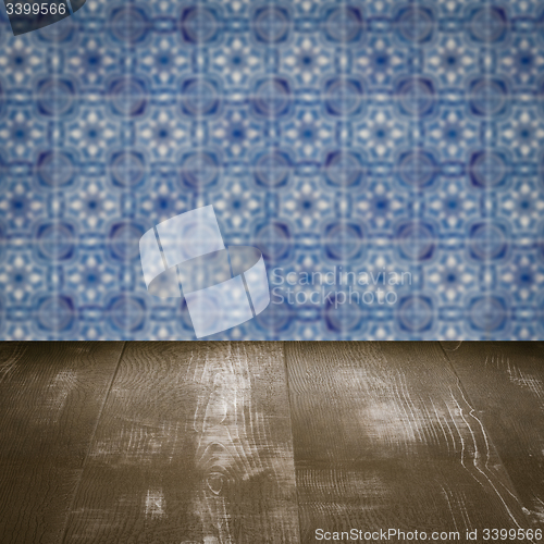 Image of Wood table top and blur vintage ceramic tile pattern wall