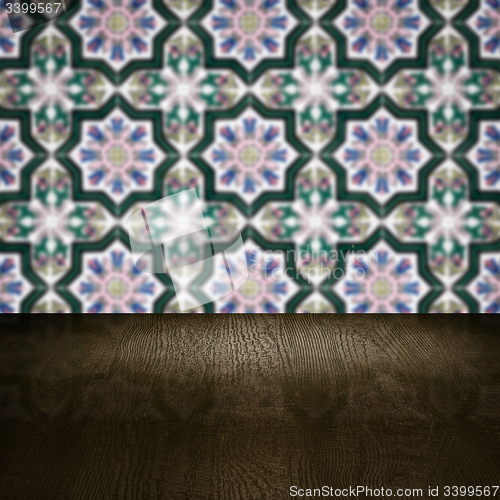 Image of Wood table top and blur vintage ceramic tile pattern wall