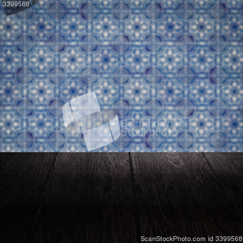 Image of Wood table top and blur vintage ceramic tile pattern wall