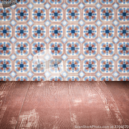 Image of Wood table top and blur vintage ceramic tile pattern wall
