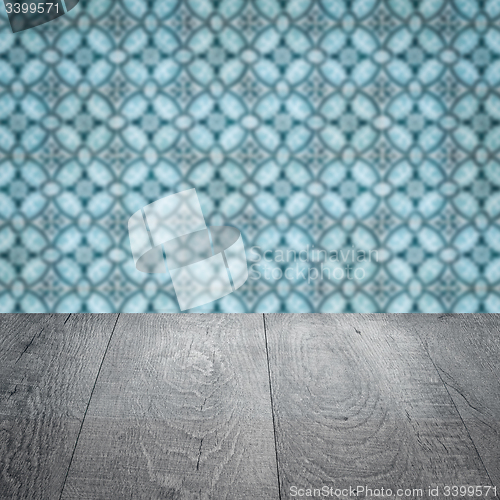 Image of Wood table top and blur vintage ceramic tile pattern wall