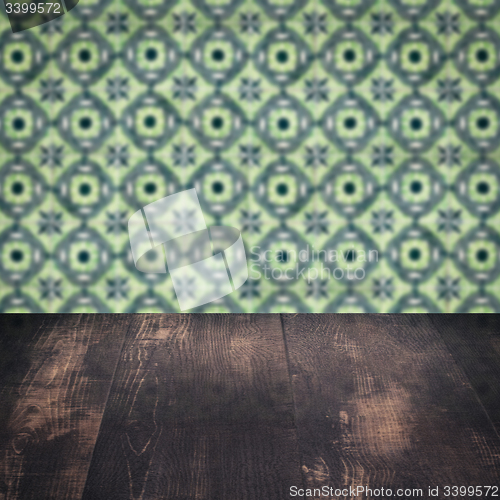 Image of Wood table top and blur vintage ceramic tile pattern wall