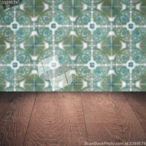 Image of Wood table top and blur vintage ceramic tile pattern wall