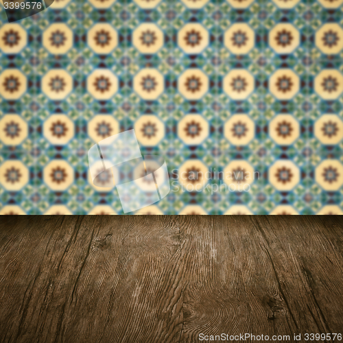 Image of Wood table top and blur vintage ceramic tile pattern wall