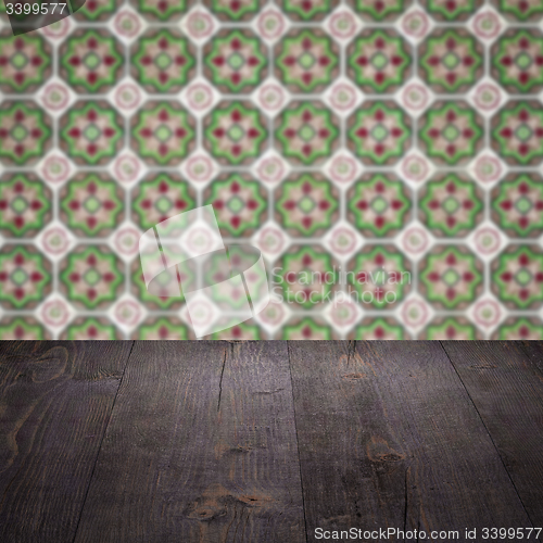 Image of Wood table top and blur vintage ceramic tile pattern wall