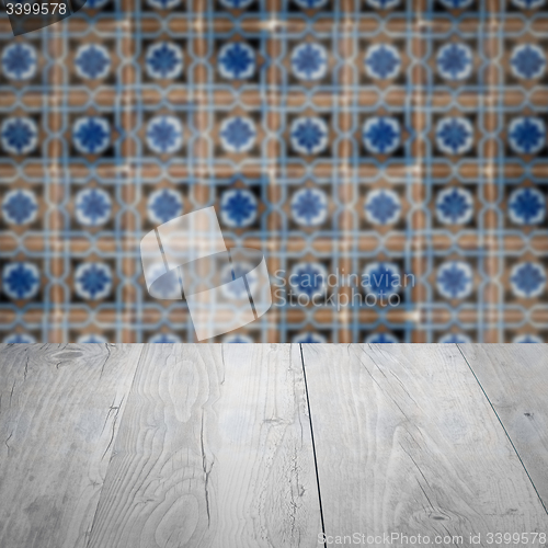 Image of Wood table top and blur vintage ceramic tile pattern wall