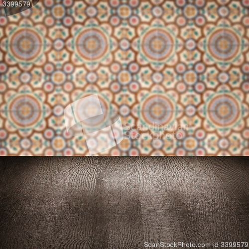 Image of Wood table top and blur vintage ceramic tile pattern wall