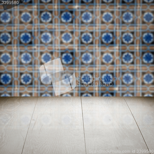 Image of Wood table top and blur vintage ceramic tile pattern wall