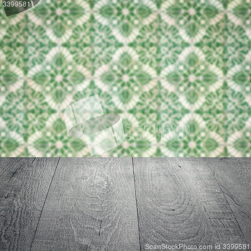 Image of Wood table top and blur vintage ceramic tile pattern wall