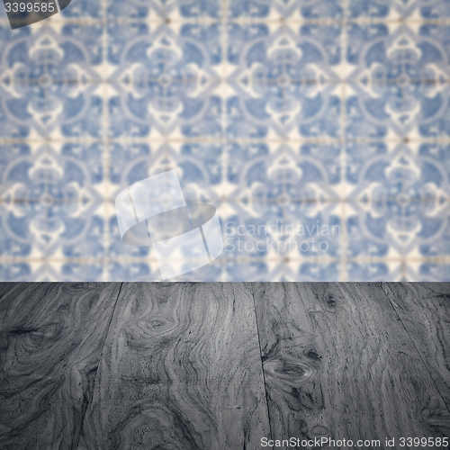 Image of Wood table top and blur vintage ceramic tile pattern wall