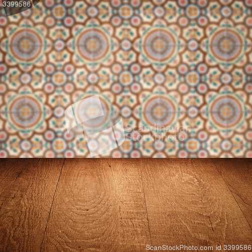 Image of Wood table top and blur vintage ceramic tile pattern wall