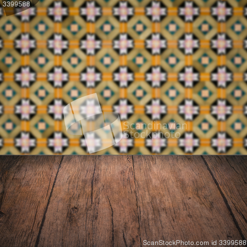 Image of Wood table top and blur vintage ceramic tile pattern wall