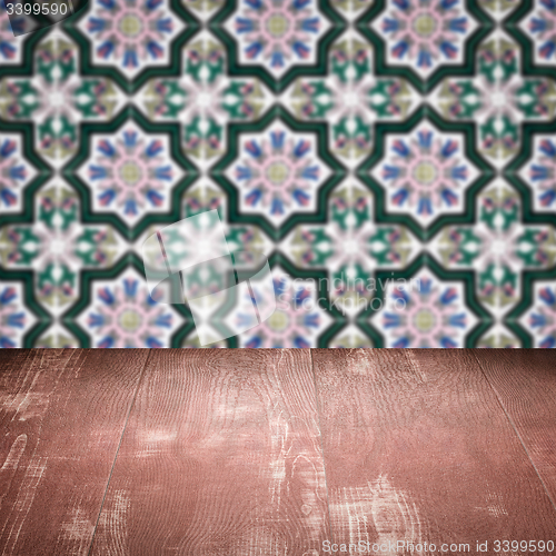 Image of Wood table top and blur vintage ceramic tile pattern wall