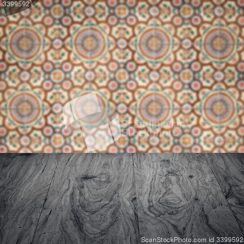 Image of Wood table top and blur vintage ceramic tile pattern wall