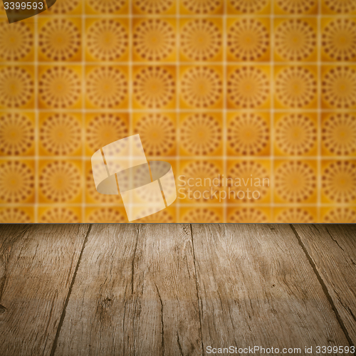 Image of Wood table top and blur vintage ceramic tile pattern wall