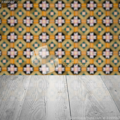 Image of Wood table top and blur vintage ceramic tile pattern wall