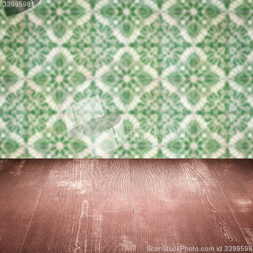 Image of Wood table top and blur vintage ceramic tile pattern wall