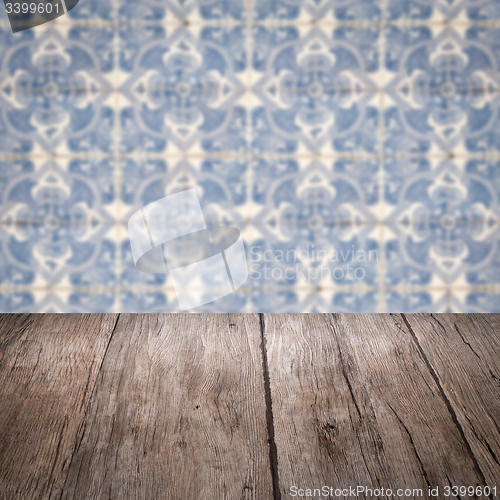 Image of Wood table top and blur vintage ceramic tile pattern wall