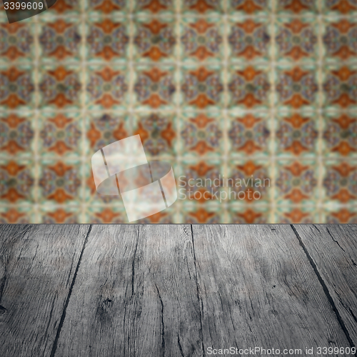 Image of Wood table top and blur vintage ceramic tile pattern wall