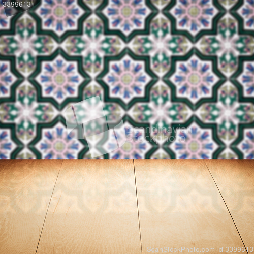 Image of Wood table top and blur vintage ceramic tile pattern wall