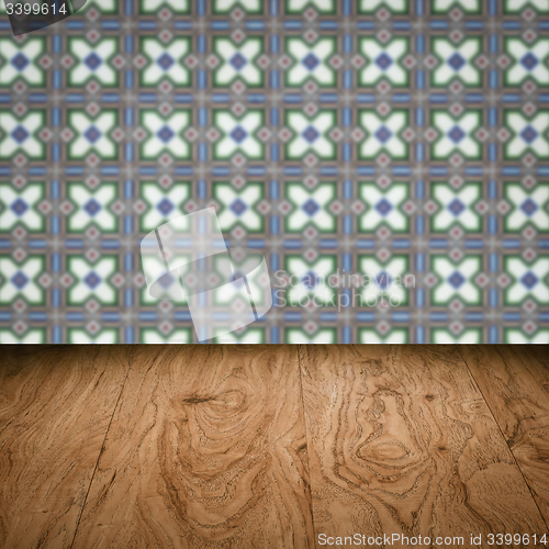 Image of Wood table top and blur vintage ceramic tile pattern wall