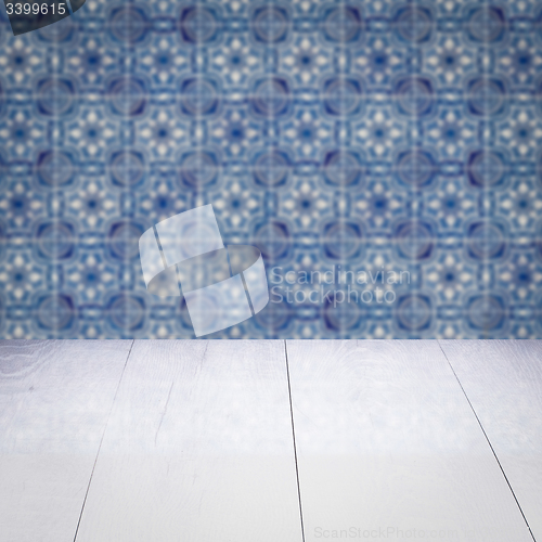 Image of Wood table top and blur vintage ceramic tile pattern wall