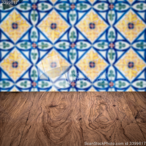 Image of Wood table top and blur vintage ceramic tile pattern wall