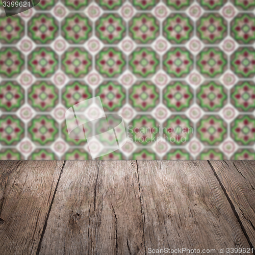 Image of Wood table top and blur vintage ceramic tile pattern wall