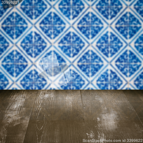 Image of Wood table top and blur vintage ceramic tile pattern wall