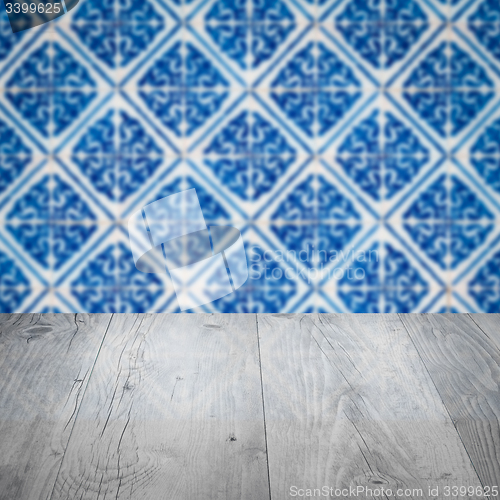 Image of Wood table top and blur vintage ceramic tile pattern wall