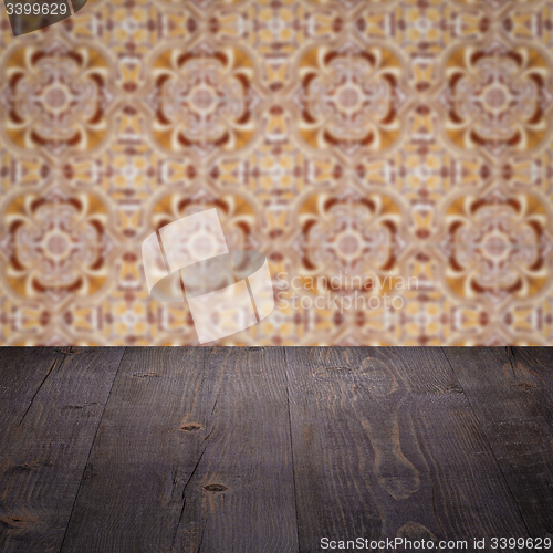 Image of Wood table top and blur vintage ceramic tile pattern wall