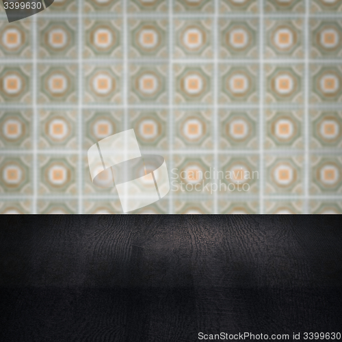 Image of Wood table top and blur vintage ceramic tile pattern wall