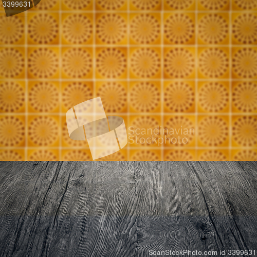 Image of Wood table top and blur vintage ceramic tile pattern wall