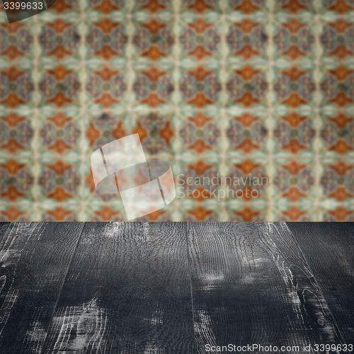 Image of Wood table top and blur vintage ceramic tile pattern wall