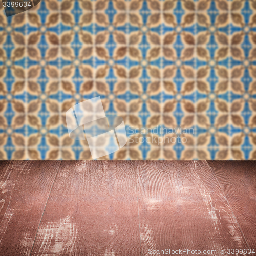 Image of Wood table top and blur vintage ceramic tile pattern wall