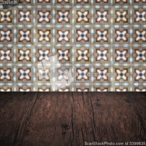 Image of Wood table top and blur vintage ceramic tile pattern wall