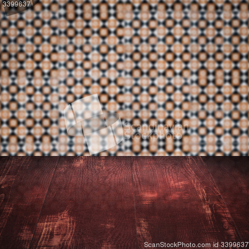 Image of Wood table top and blur vintage ceramic tile pattern wall