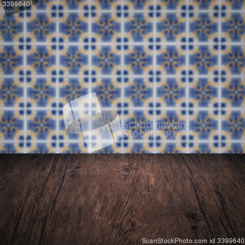 Image of Wood table top and blur vintage ceramic tile pattern wall