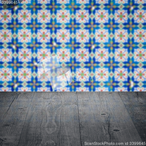 Image of Wood table top and blur vintage ceramic tile pattern wall
