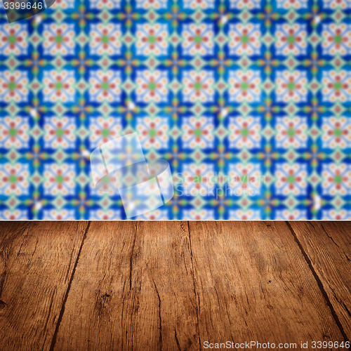 Image of Wood table top and blur vintage ceramic tile pattern wall