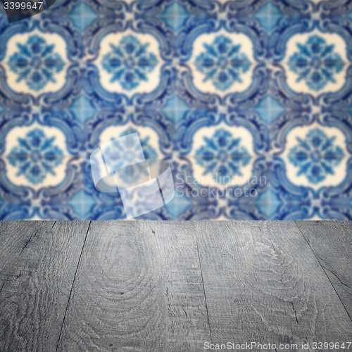 Image of Wood table top and blur vintage ceramic tile pattern wall