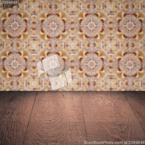 Image of Wood table top and blur vintage ceramic tile pattern wall