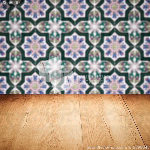 Image of Wood table top and blur vintage ceramic tile pattern wall