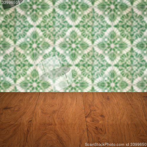 Image of Wood table top and blur vintage ceramic tile pattern wall
