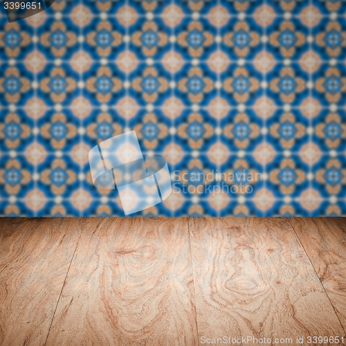 Image of Wood table top and blur vintage ceramic tile pattern wall